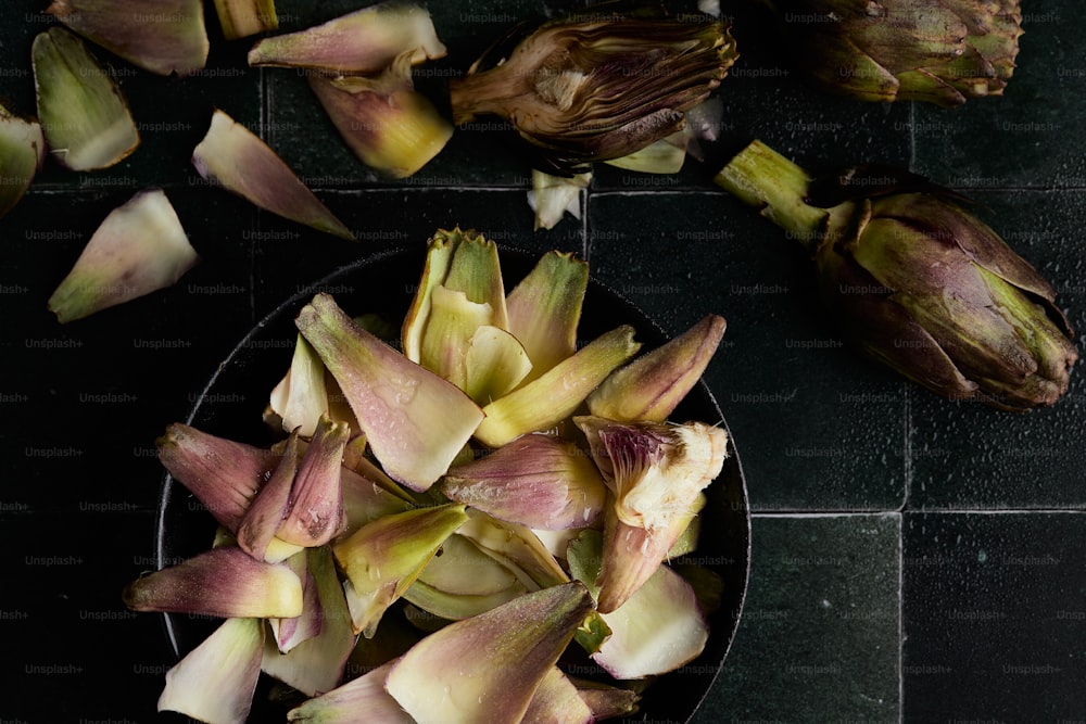 a plate of artichokes on a black table