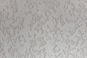 eine Nahaufnahme einer Wand mit weißer Farbe