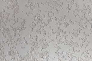 a close up of a wall with white paint