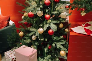 a small christmas tree with red and gold ornaments