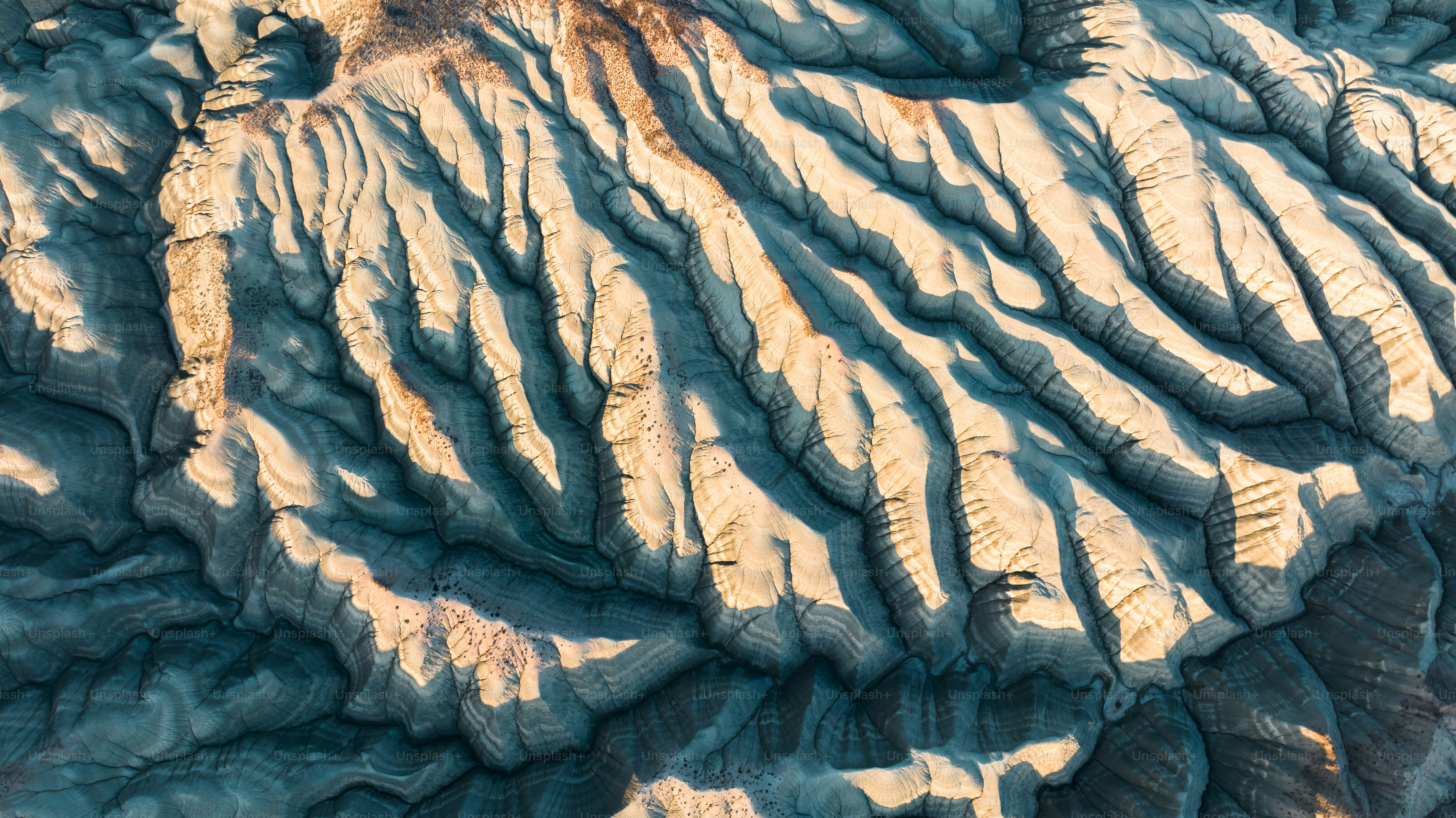 An aerial view of a mountain range at sunset photo – Travel Image on ...