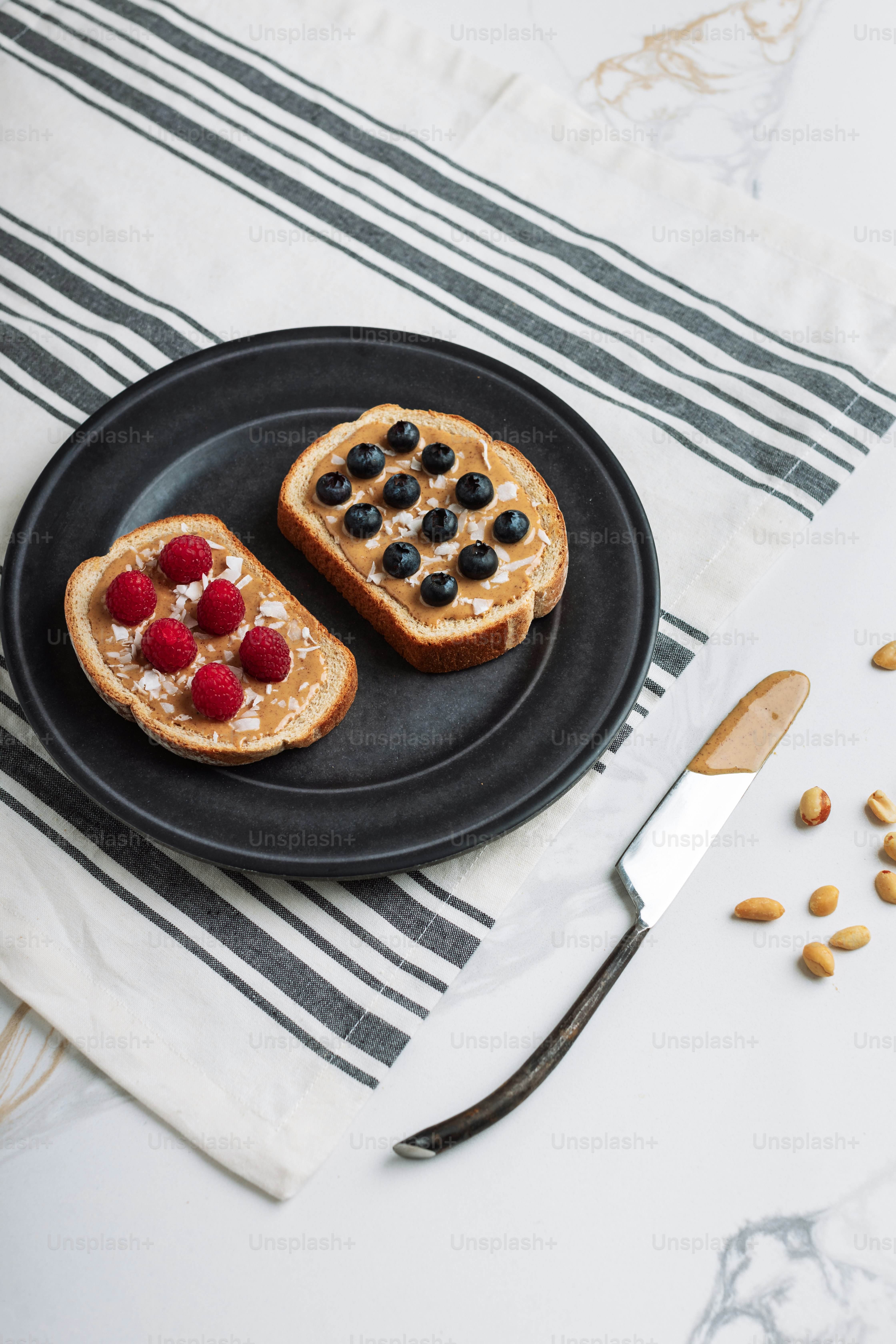 a black plate topped with two pieces of toast