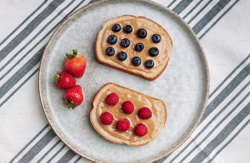 two pieces of toast with berries on a plate