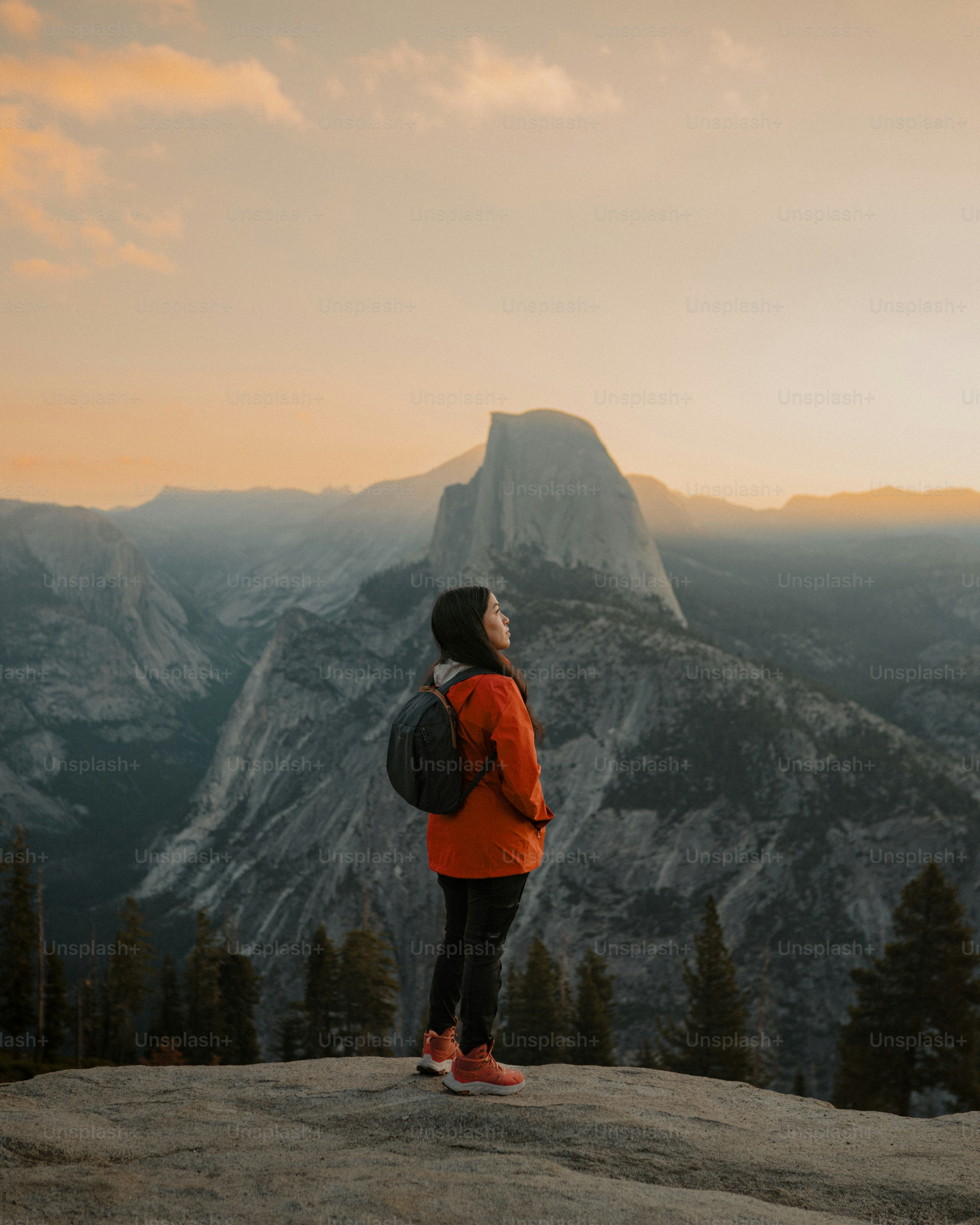 a person standing on top of a mountain with a backpack