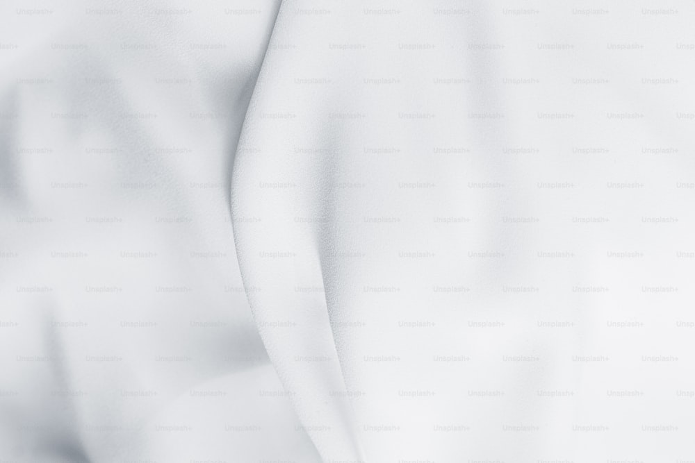 a close up of a white sheet with a white background
