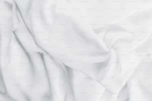 Eine Nahaufnahme eines weißen Lakens auf einem Bett