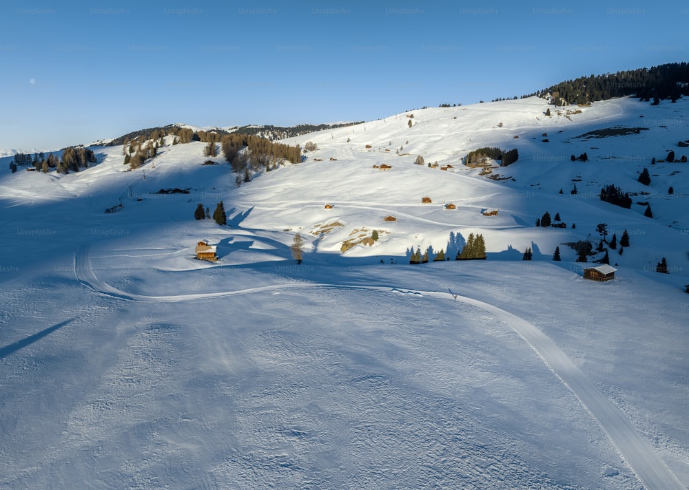 a snow covered mountain with a small cabin on top of it