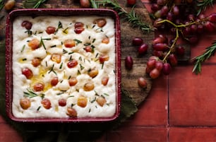 a dish of food on a table with grapes