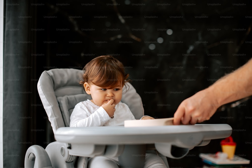 a small child sitting in a high chair