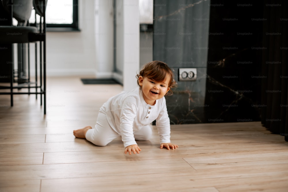 a baby crawling on the floor in a room