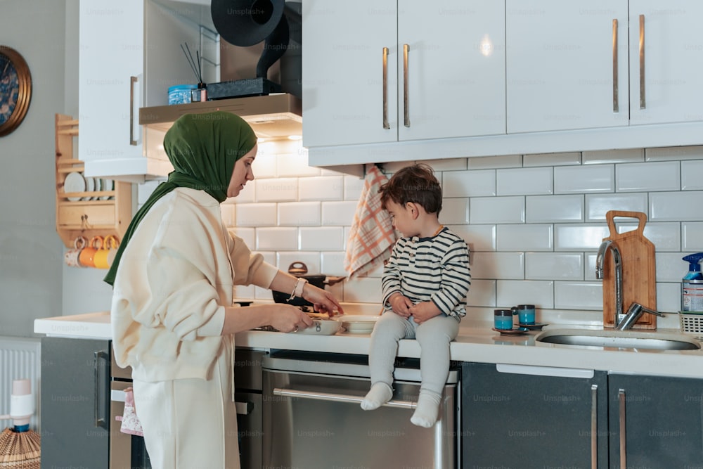 a woman and a child in a kitchen