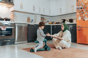 a woman and a child playing in a kitchen