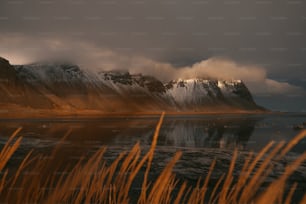 the mountains are covered in snow and clouds