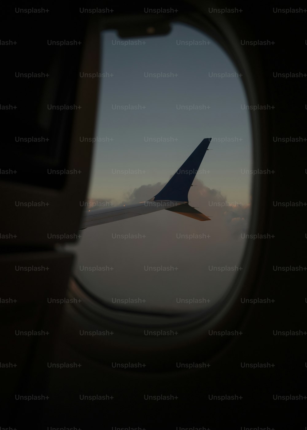 a view of the wing of an airplane through a window