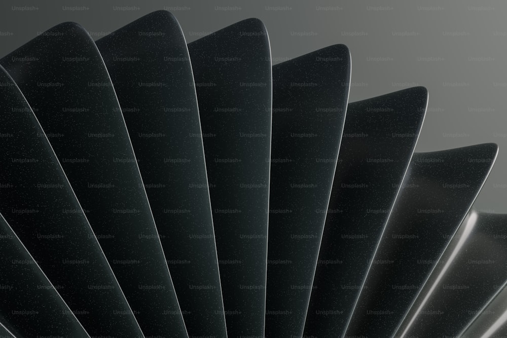 a close up of a black fan on a gray background