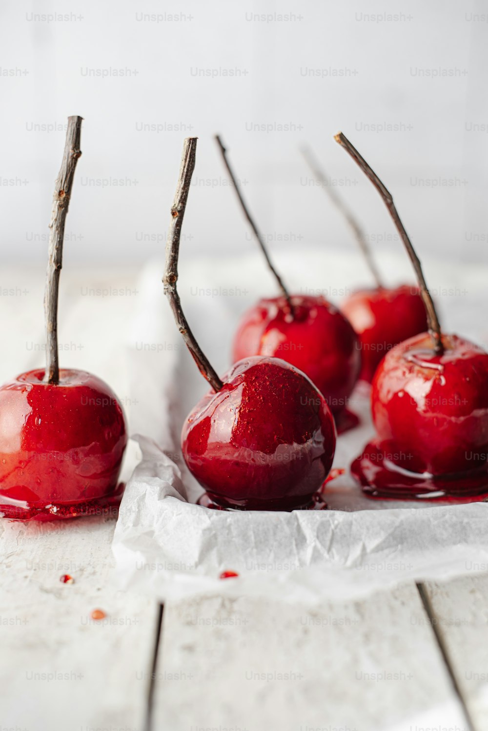 a group of cherries sitting on top of a white table