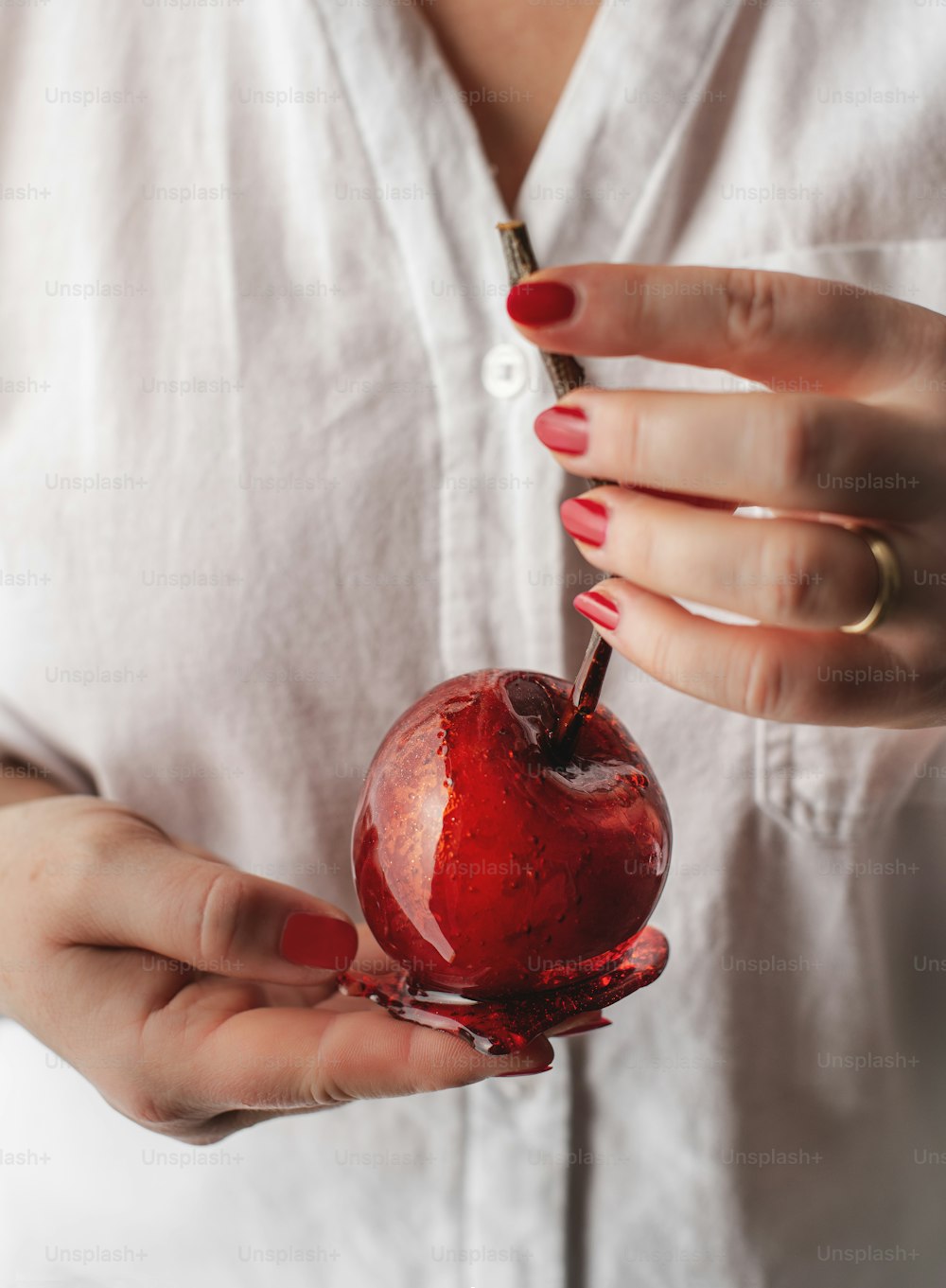 a woman holding an apple with a bite taken out of it