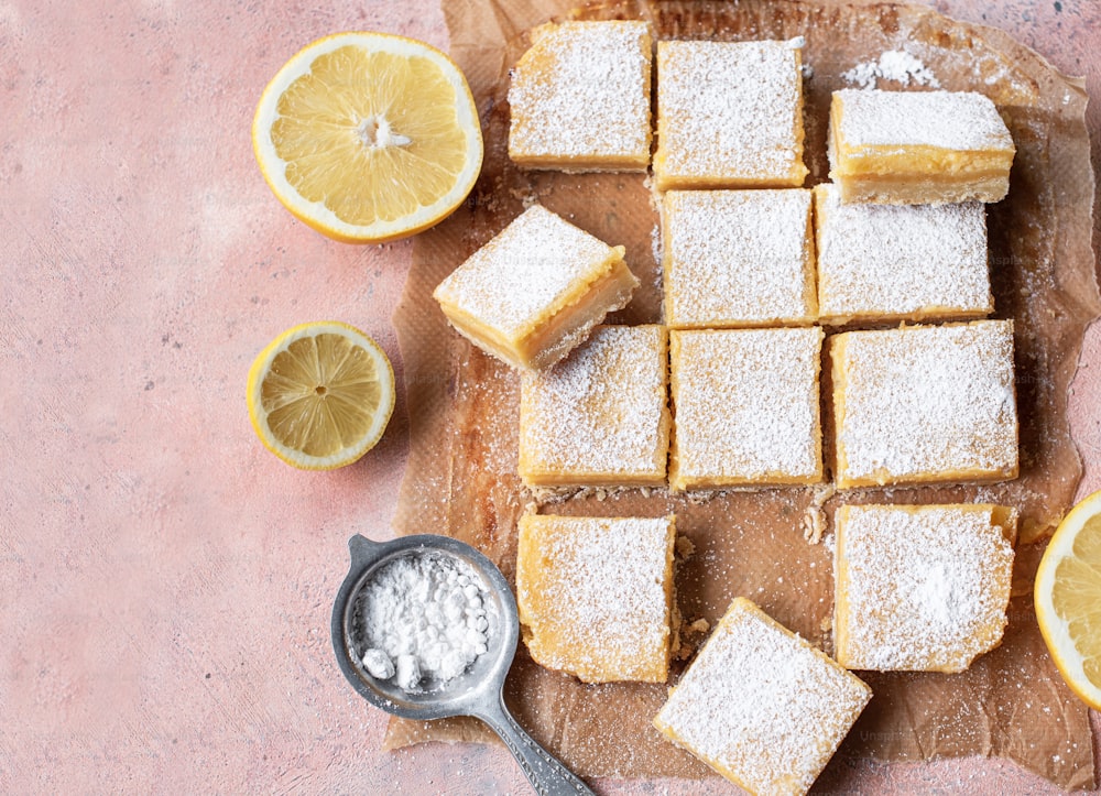 a wooden cutting board topped with lemon bars