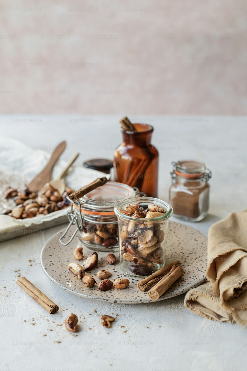 a table topped with jars filled with nuts