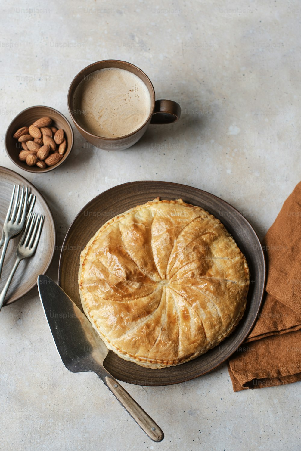 a table topped with a pie and two cups of coffee