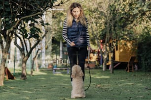 a woman walking a dog on a leash