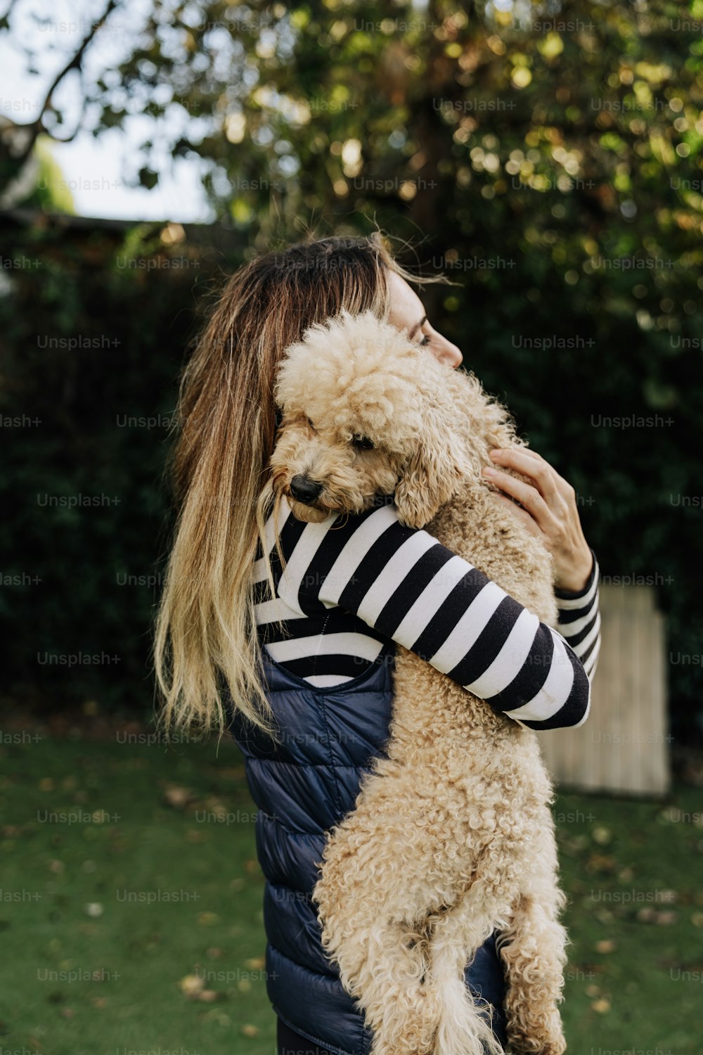 a woman holding a dog in her arms