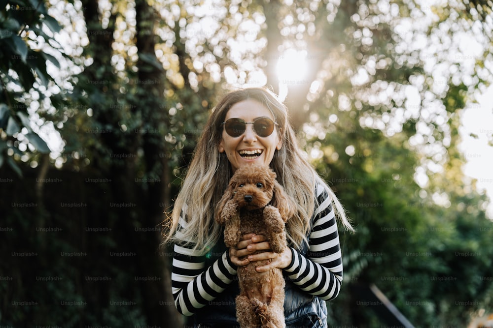 a woman in a striped shirt holding a dog