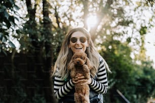 a woman in a striped shirt holding a dog