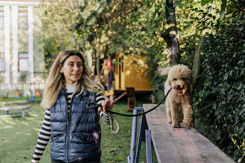 a woman walking a dog on a leash