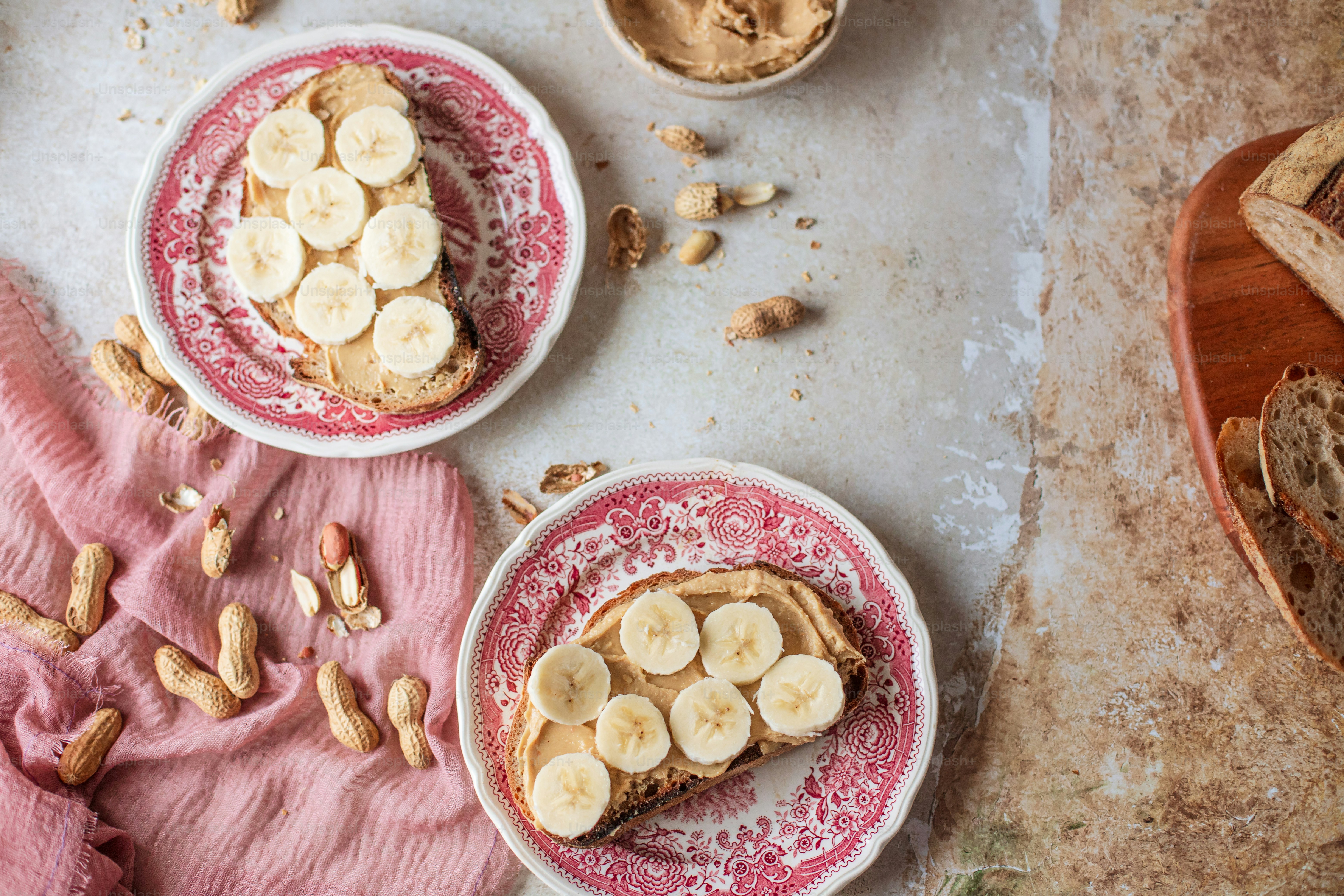 two-plates-of-food-with-peanut-butter-and-bananas-on-them-photo