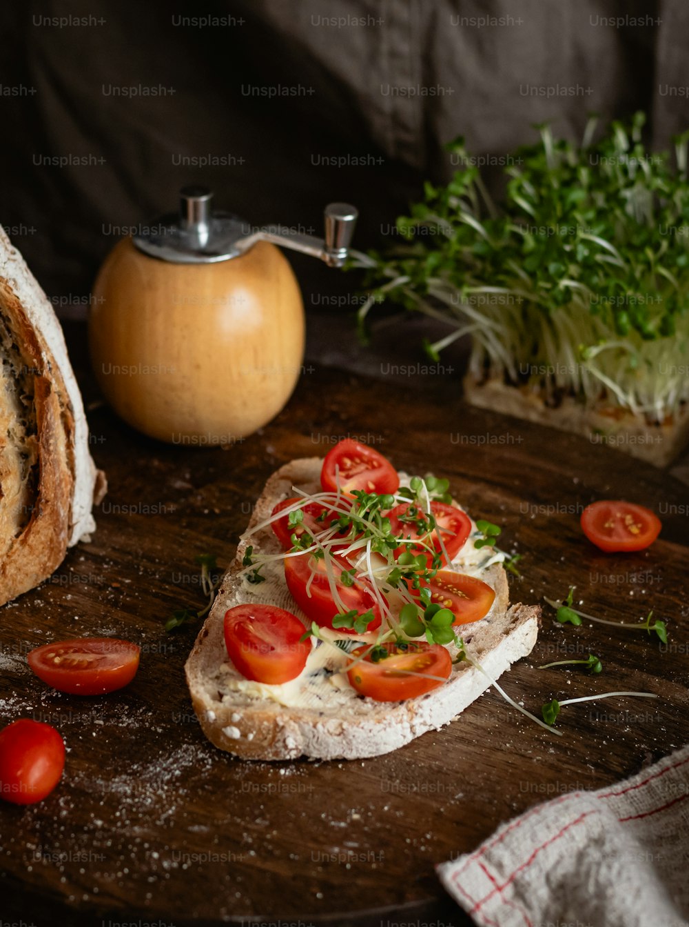 a piece of bread with tomatoes and herbs on it