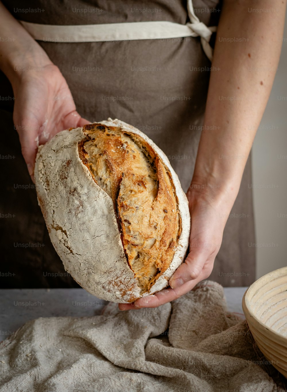 a person holding a loaf of bread in their hands