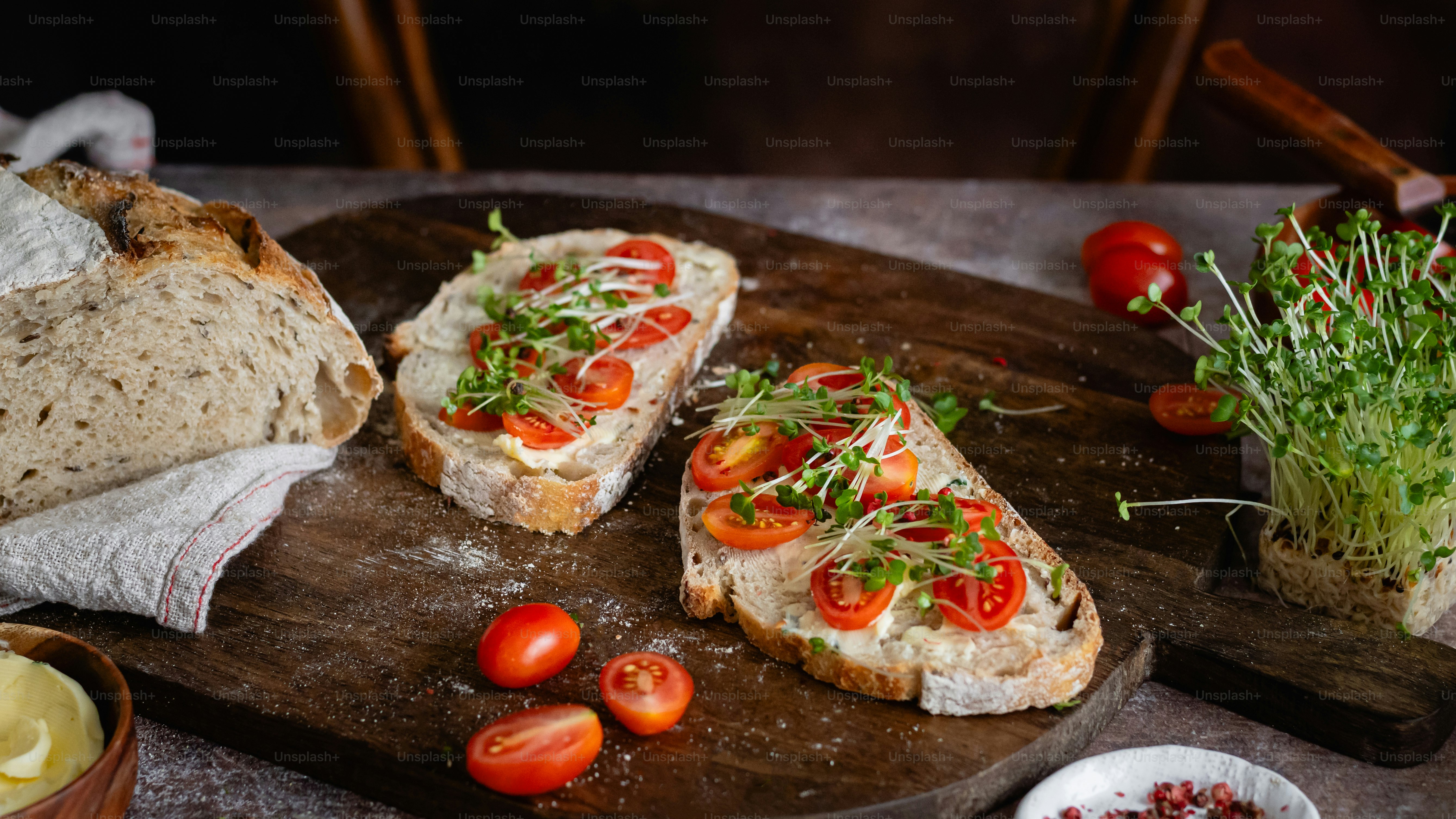 a wooden cutting board topped with slices of bread