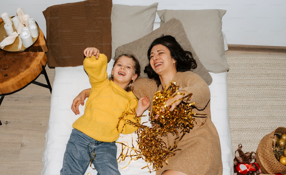a woman and a child laying on a bed