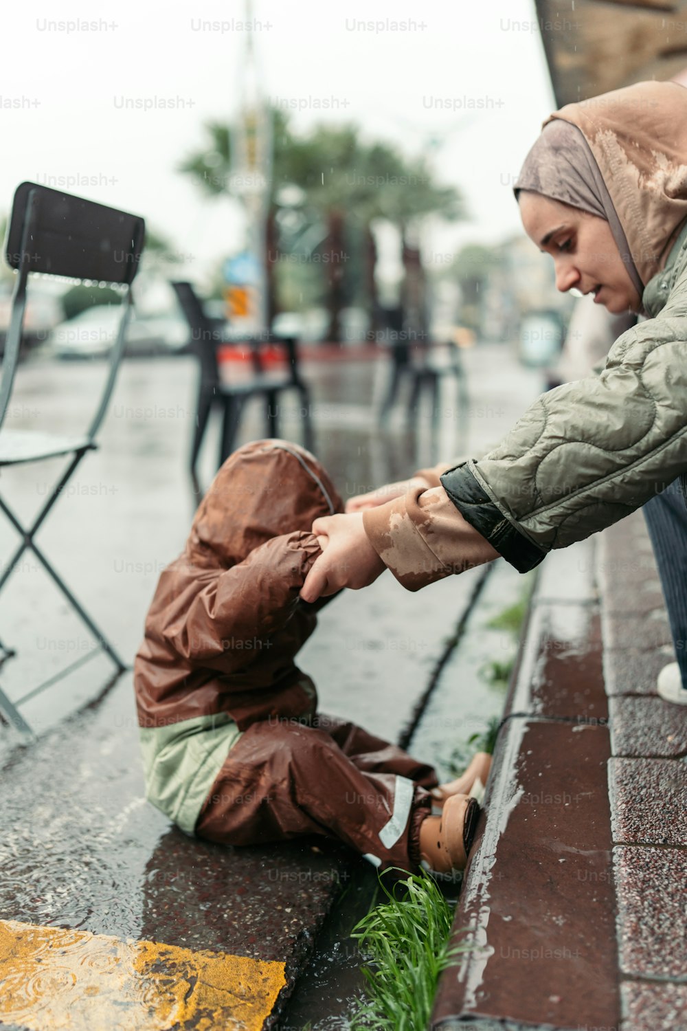 a woman handing something to a small child