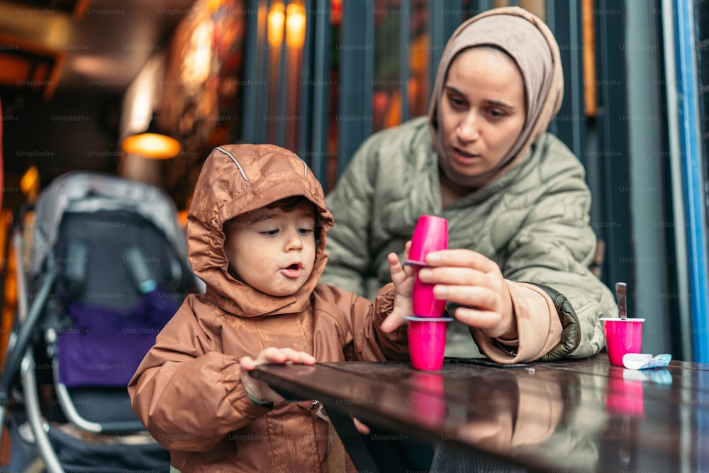 a woman and a child sitting at a table