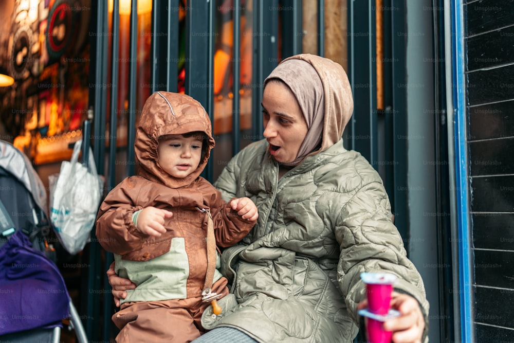 a woman holding a child on the street