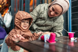 a woman and a child sitting at a table