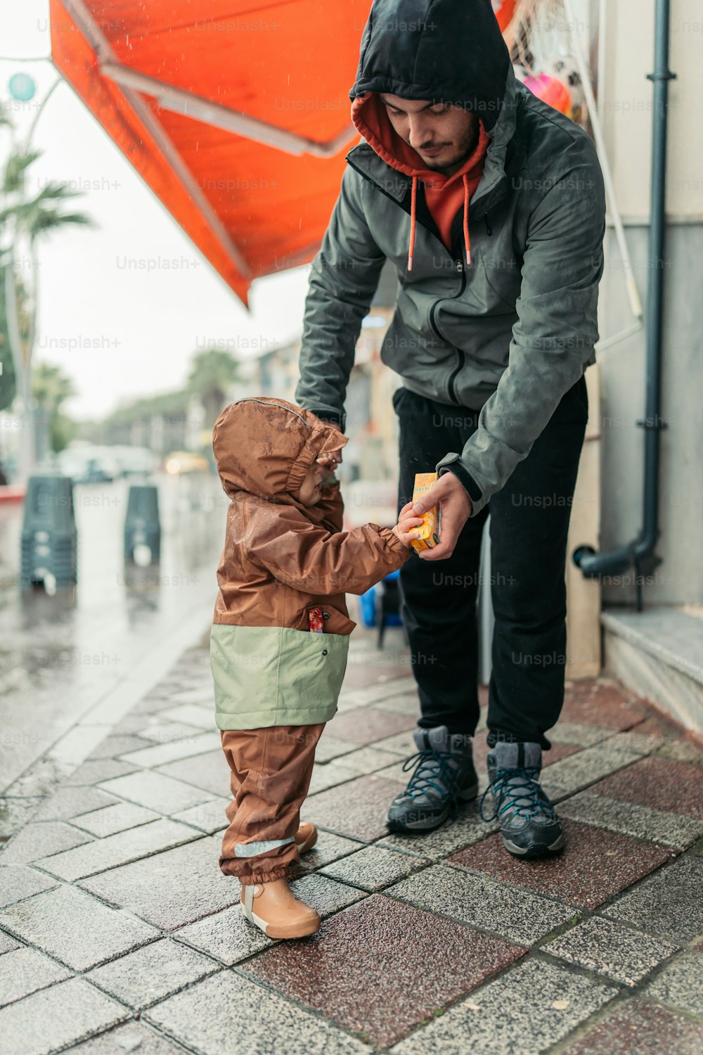 a man is holding a small child's hand