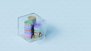 Une boîte transparente avec un tas de boutons colorés à l’intérieur