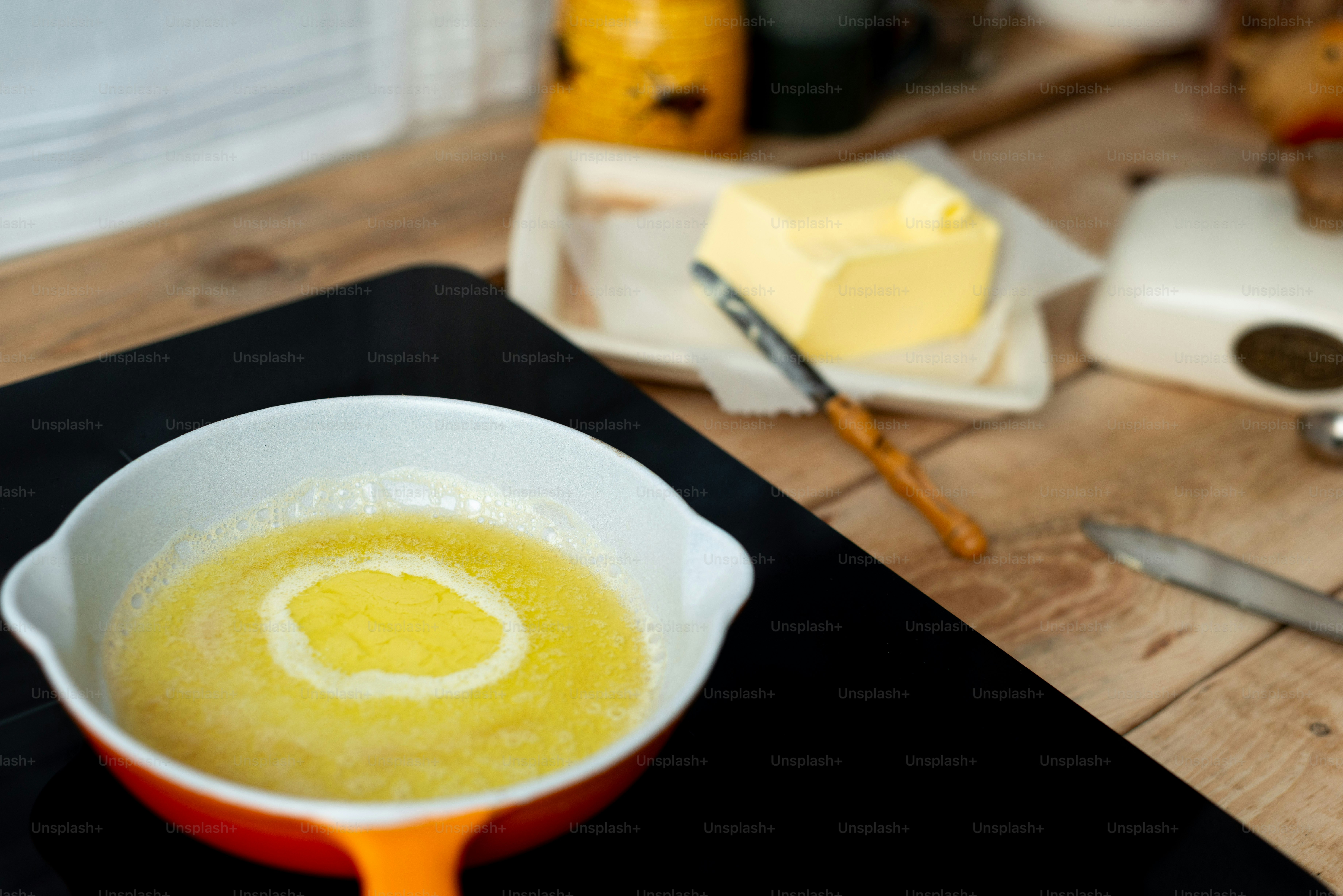 a bowl of yellow liquid sitting on top of a table