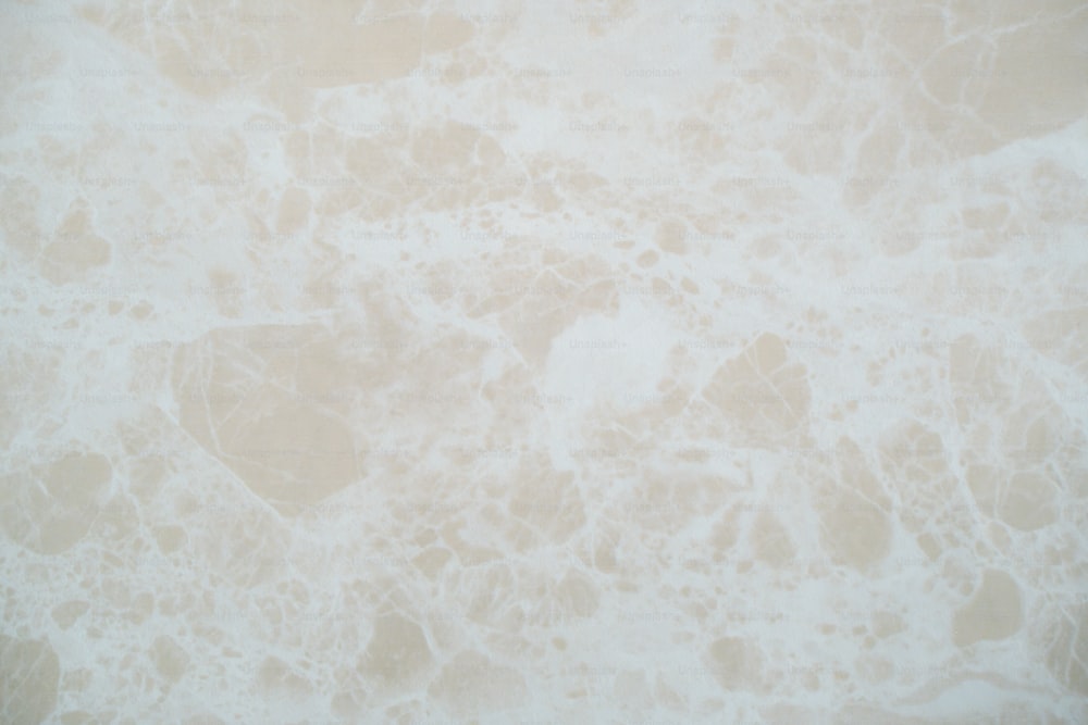 a close up of a white marble textured wall