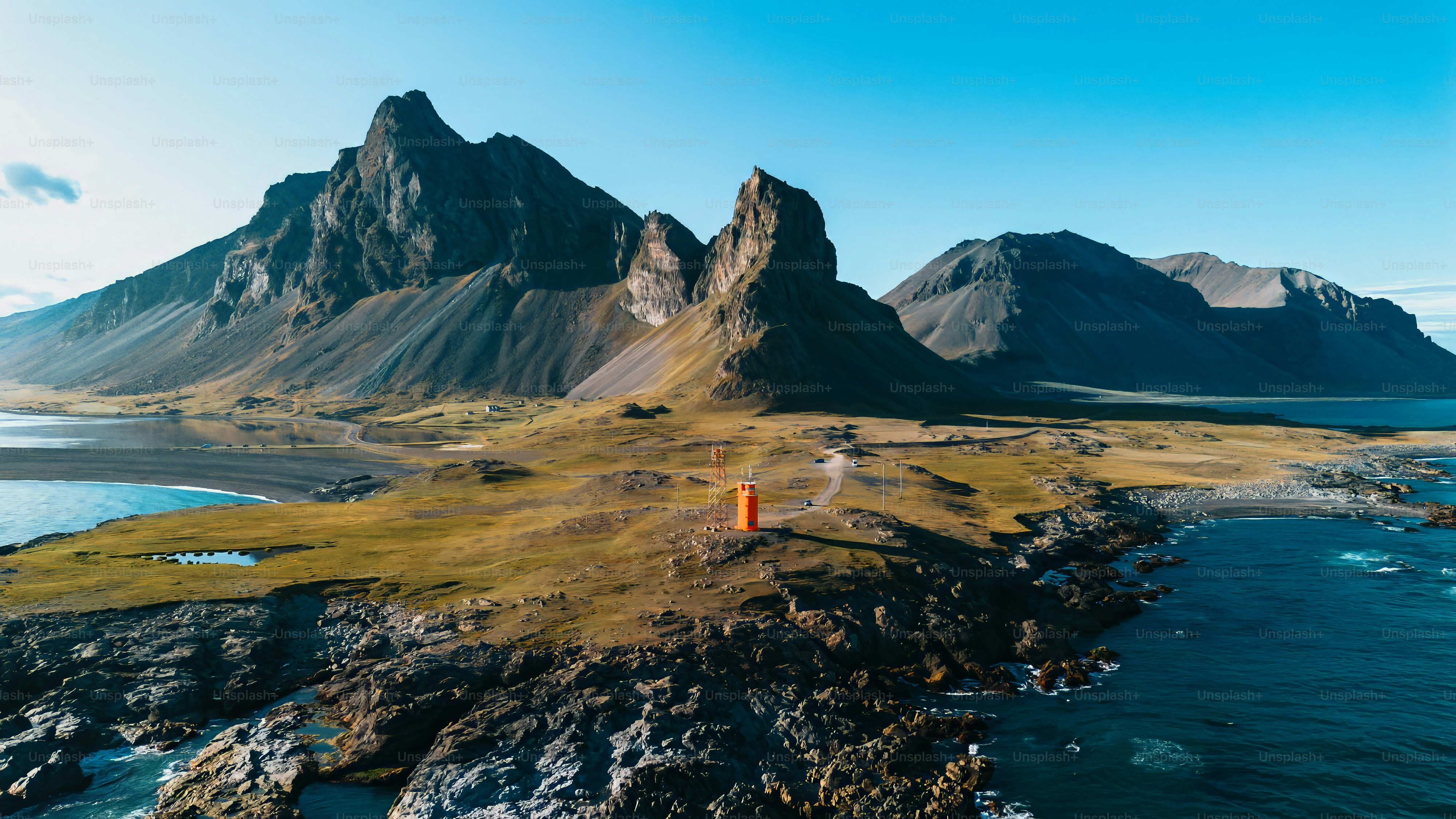 an aerial view of some mountains and a body of water