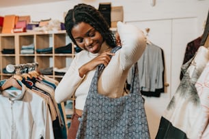 a woman looking at a bag in a clothing store