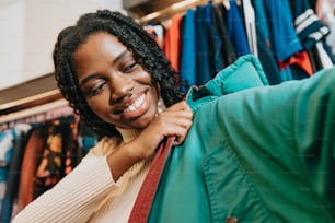 a woman is smiling while looking at a shirt