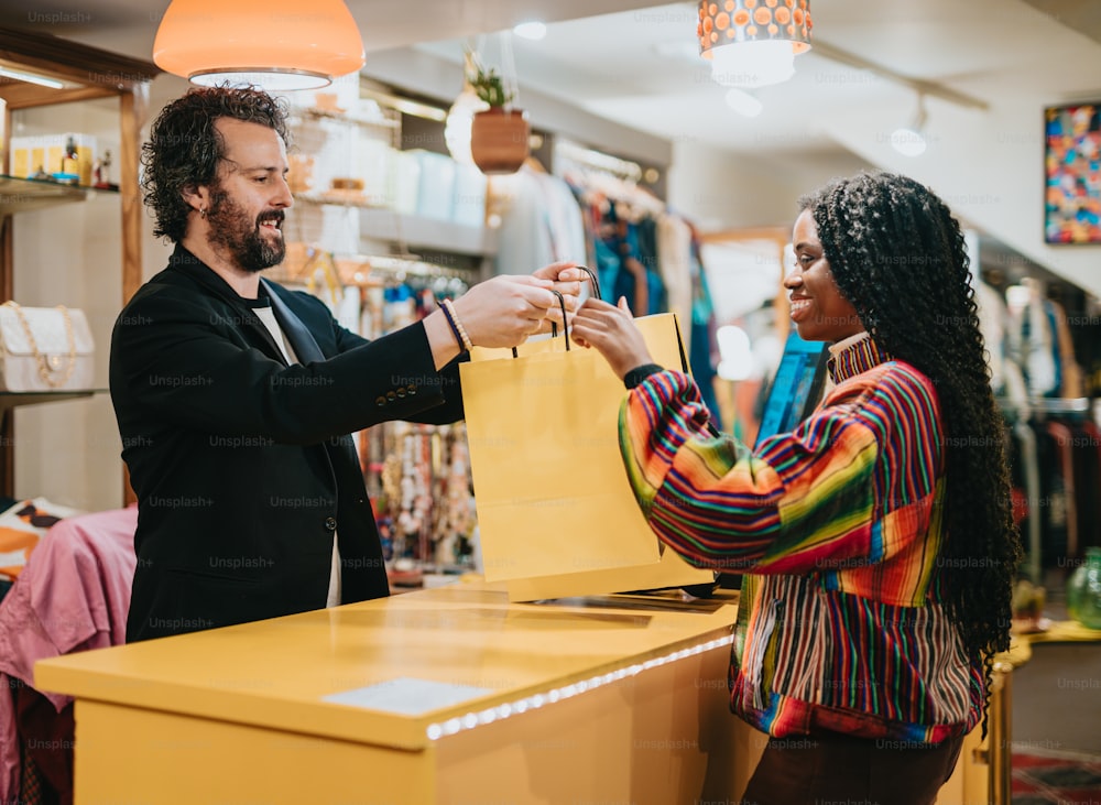 a man handing a woman a shopping bag