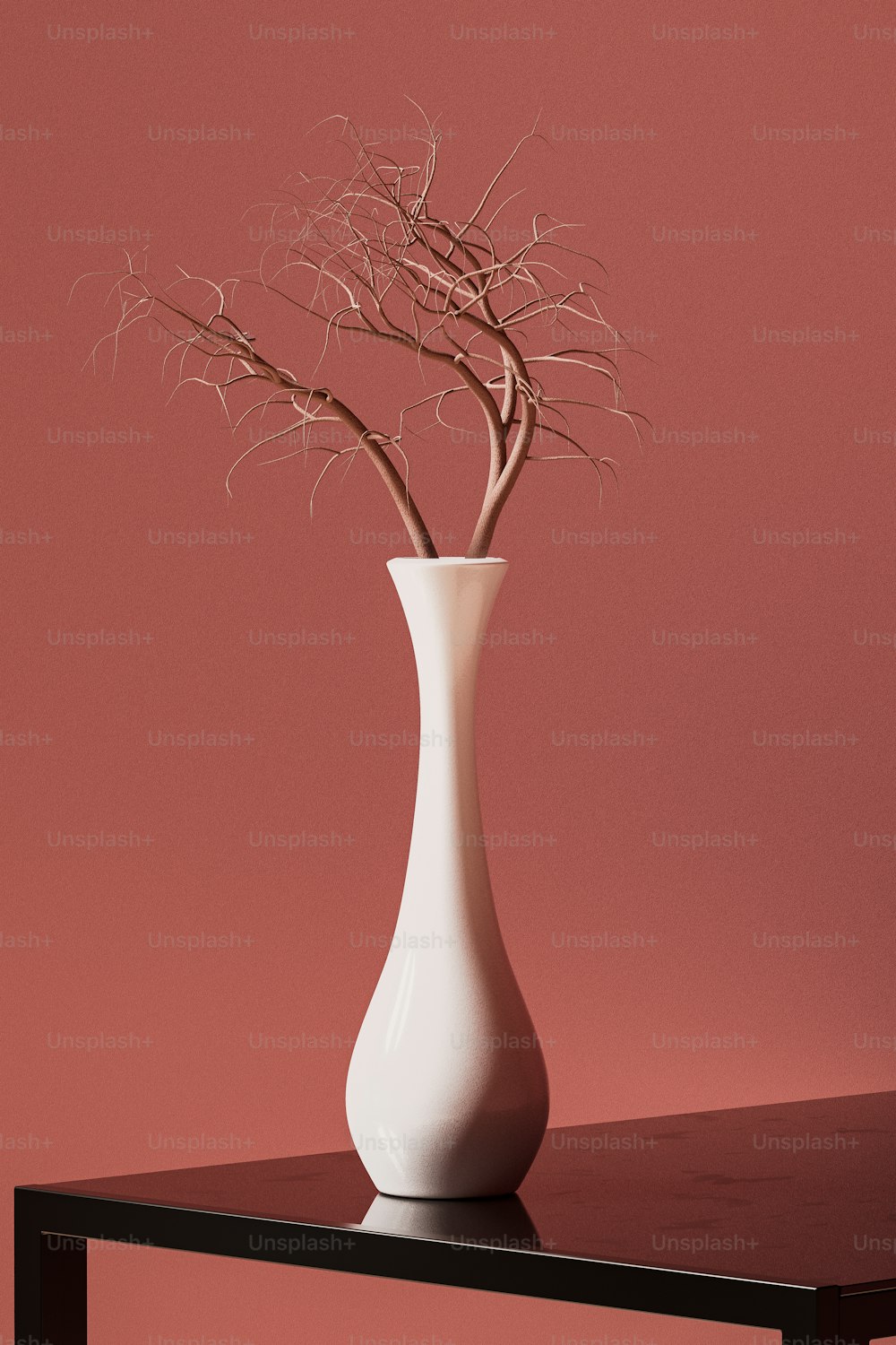 a white vase filled with branches on top of a table