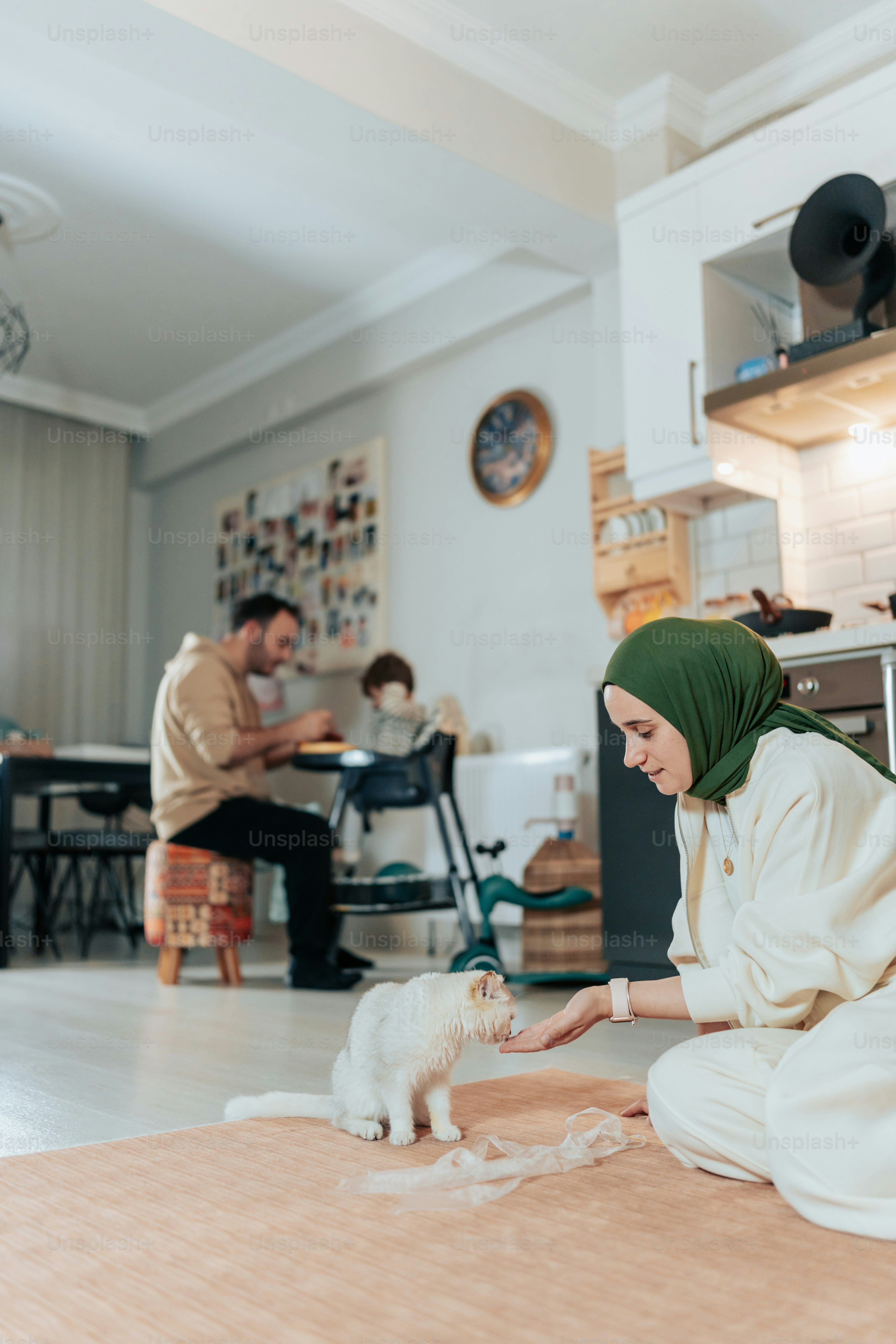 a woman sitting on the floor petting a cat