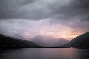 a large body of water with mountains in the background