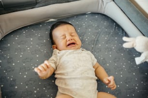 a baby is laying down in a crib